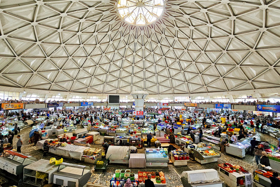 Interior del bazar Chorsu con puestos de frutas y especias